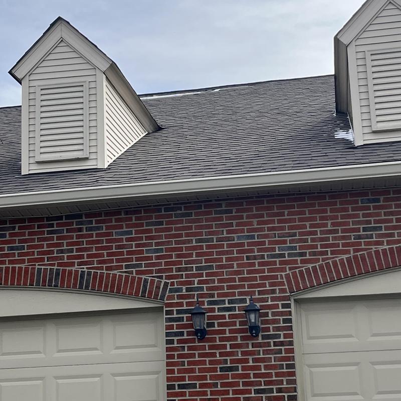 Asphalt roof shingles with minor damage near dormer vents Asphalt roof shingles with minor damage near dormer vents