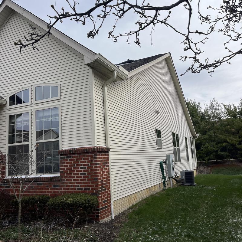 Roof shingles damaged on residential house exterior Roof shingles damaged on residential house exterior