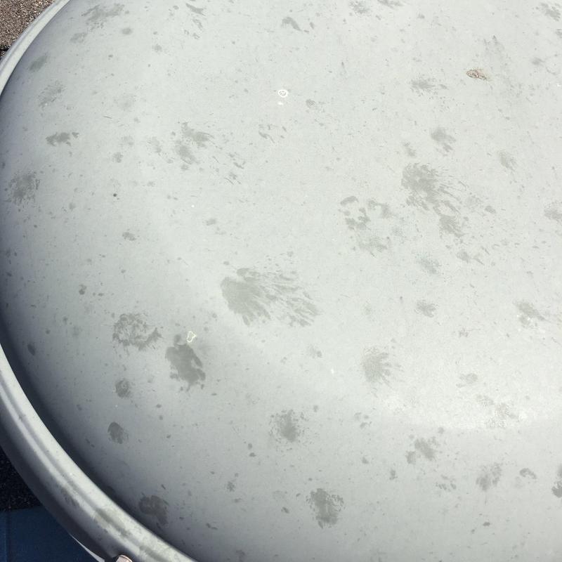 Metal water tank lid with rust spots and wear marks Metal water tank lid with rust spots and wear marks