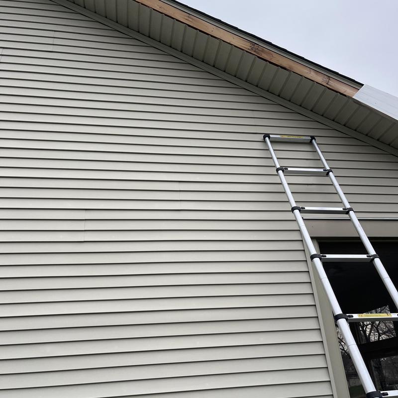 Fascia board with ladder next to house siding Fascia board with ladder next to house siding