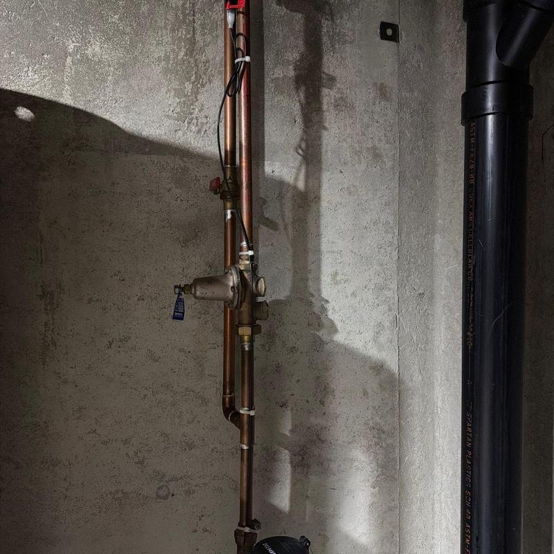Main water line with pressure regulator valve and piping