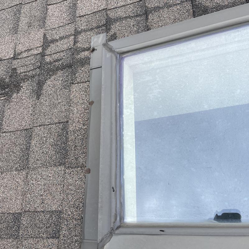 Roof skylight with flashing on shingle roof Roof skylight with flashing on shingle roof