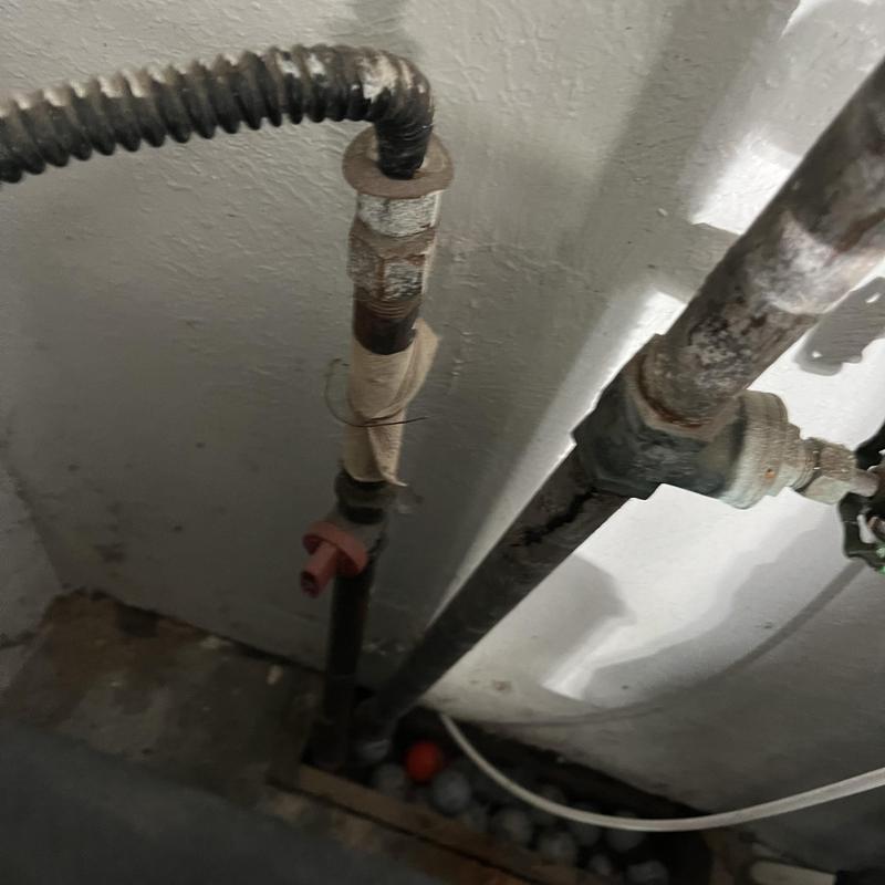 Galvanized water piping with corroded fittings in basement