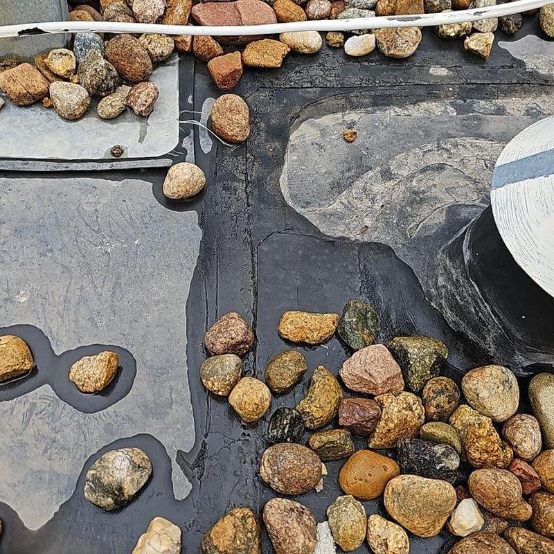 EPDM flat roof showing damaged seams and ballasts EPDM flat roof showing damaged seams and ballasts