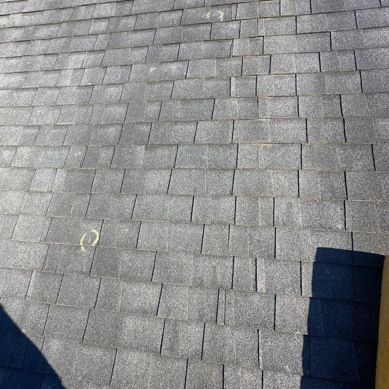 Asphalt shingle roof with hail damage markings
