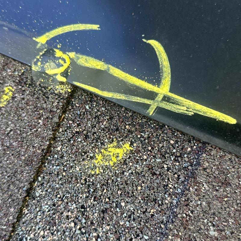 Roof shingle hail damage marked with yellow chalk