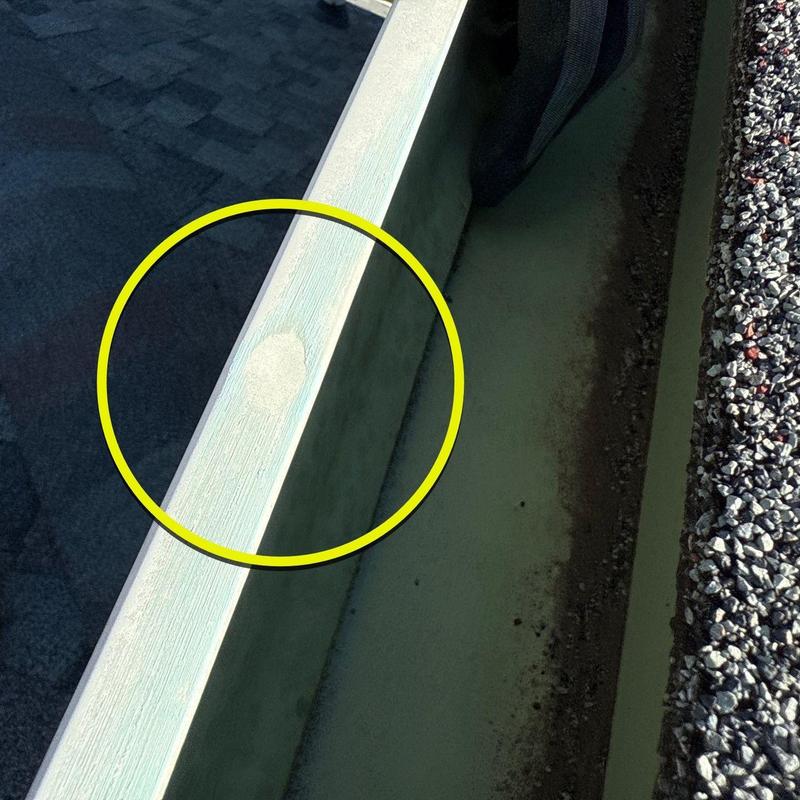 Gutter with paint damage marked by yellow circle