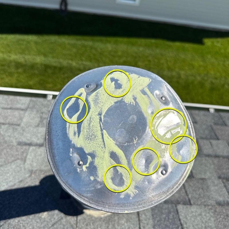 Roof vent cap with hail impact damage marks