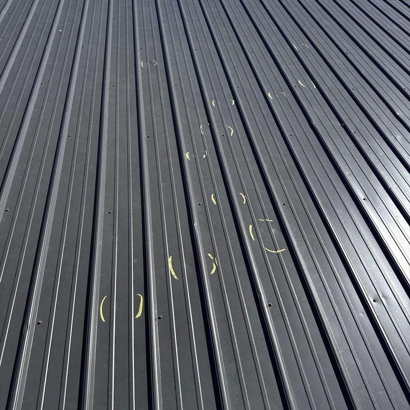 Metal roof panels with hail damage markings