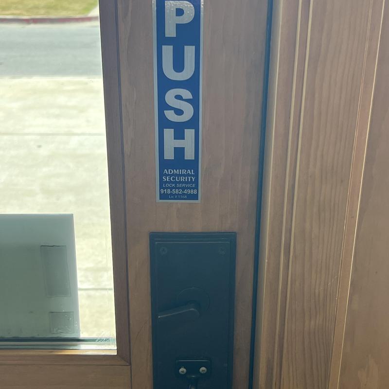 Adams Rite commercial door latch on wooden door