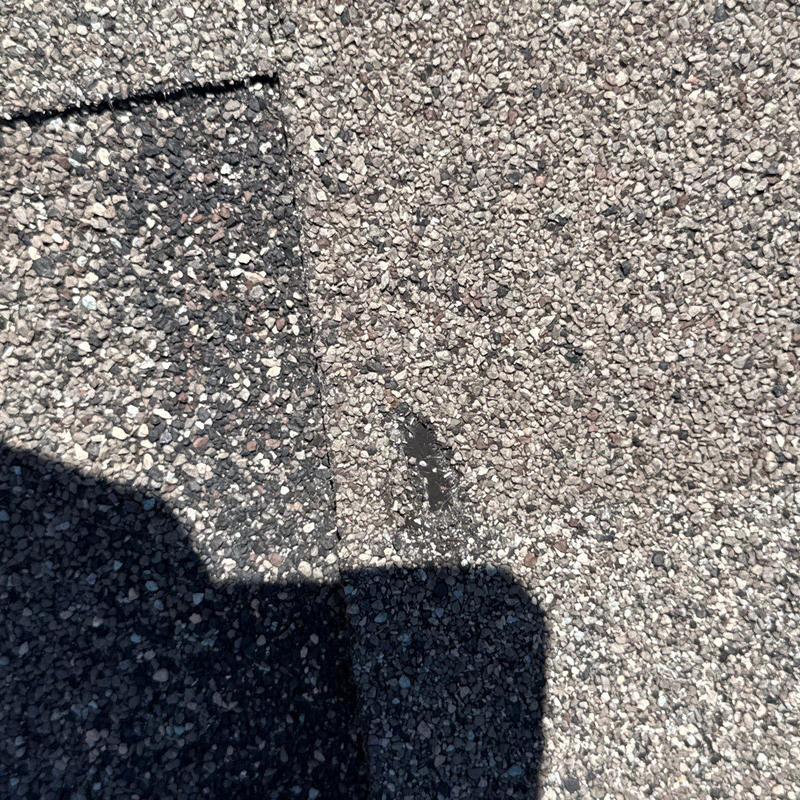 Asphalt shingle surface with hail damage and granule loss