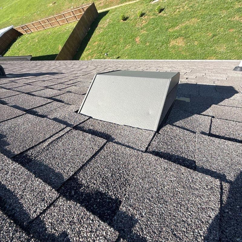 Roof vent and shingle surface with hail dents