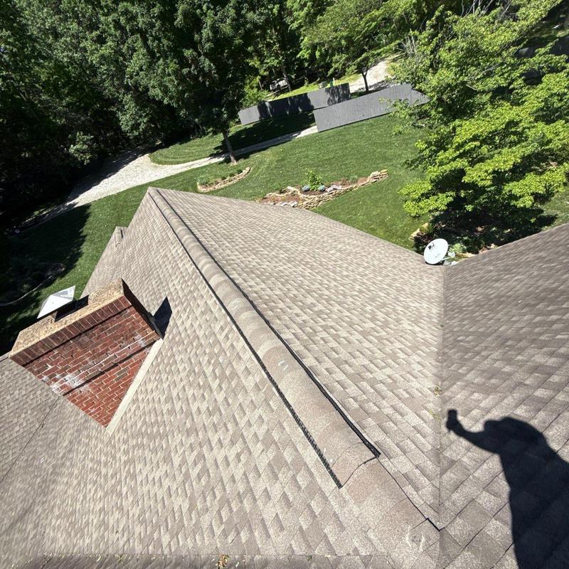 Roof shingles and chimney with ridge vent inspection