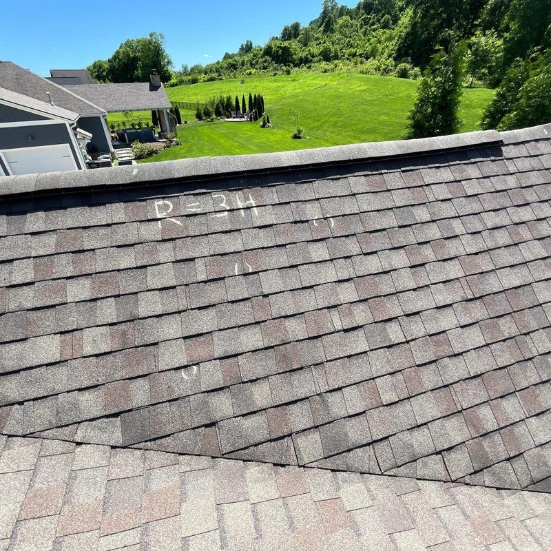 Asphalt shingle roof with hail damage markings