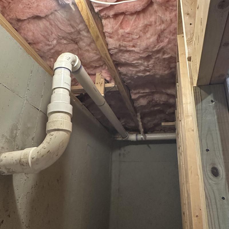 Drain line PVC piping under ceiling with insulation above