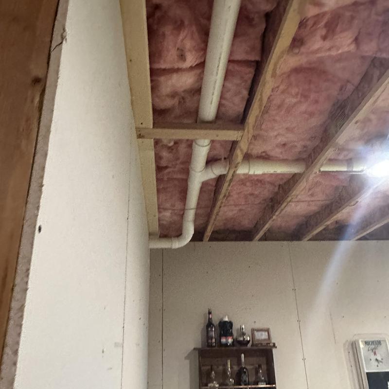 PVC drain pipes installation with ceiling insulation exposed