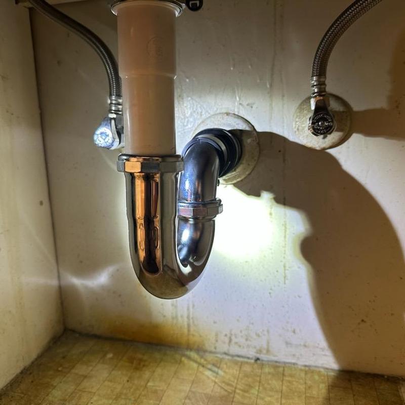 Lavatory sink p-trap and drain pipes under cabinet