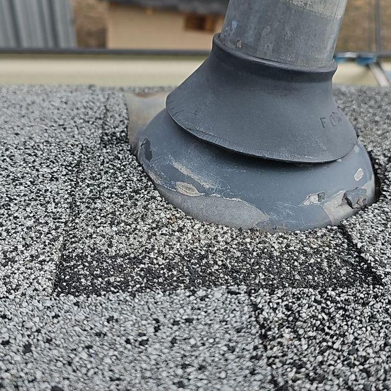 Pipe jack flashing on shingle roof with wear damage Pipe jack flashing on shingle roof with wear damage