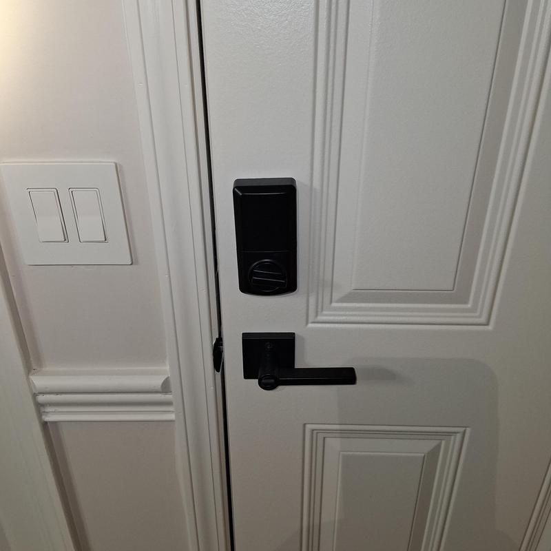 Smart key door lock installation on white door