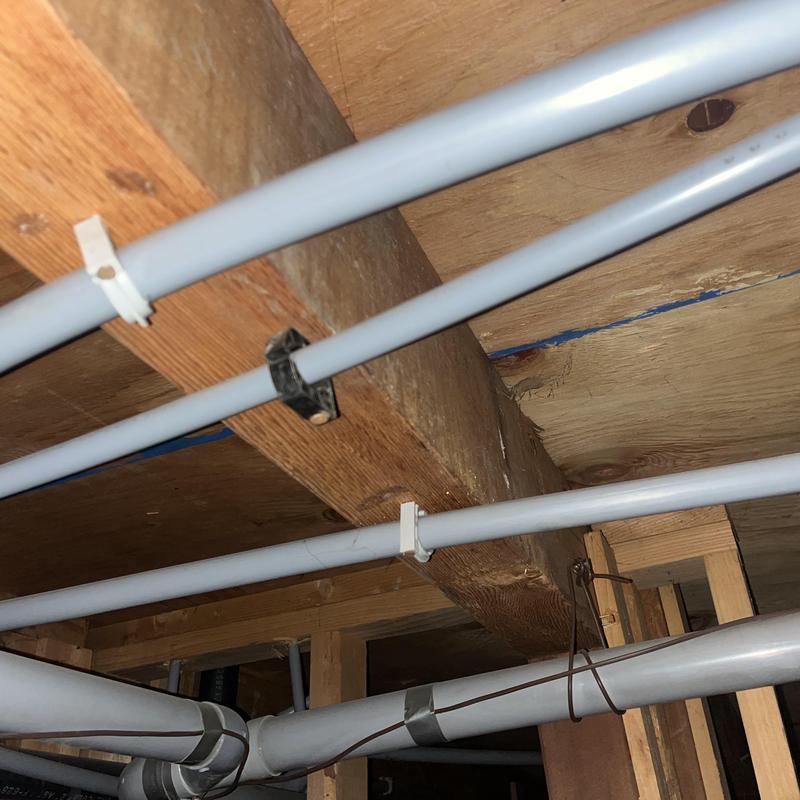 Pex piping and fittings installed under wooden floor joists