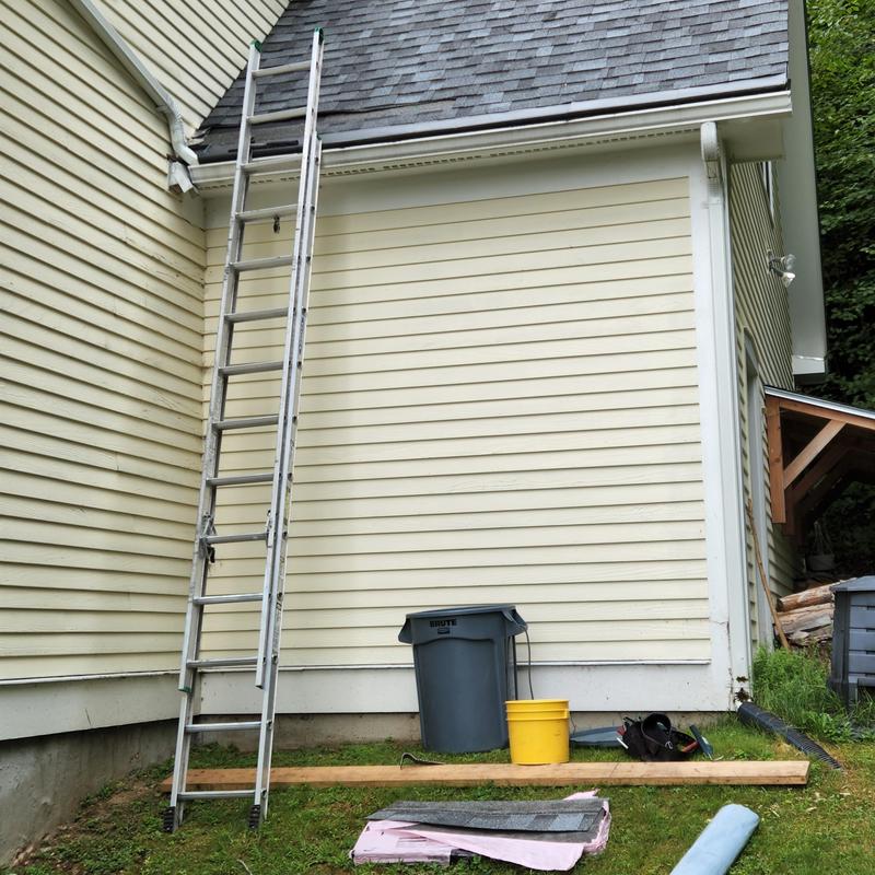Roof shingles installation tools and ladder setup Roof shingles installation tools and ladder setup