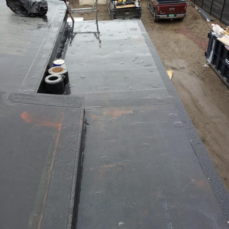 EPDM rubber flat roof membrane with sealant repairs EPDM rubber flat roof membrane with sealant repairs