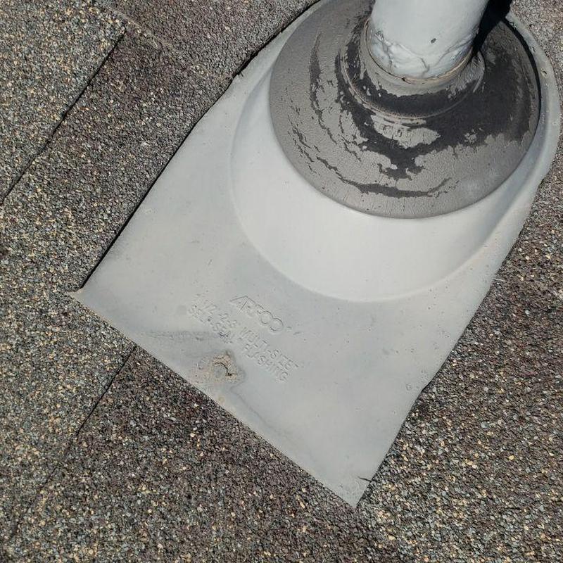 Roof pipe boot with resealed flashing on shingles Roof pipe boot with resealed flashing on shingles