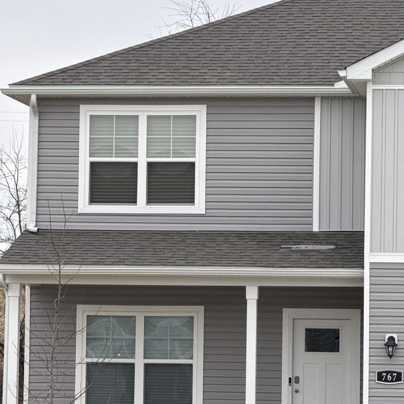 Asphalt shingles on roof with slight storm damage Asphalt shingles on roof with slight storm damage