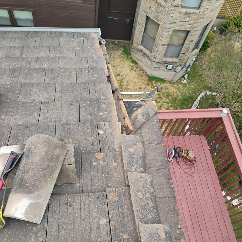 Concrete roof tile with loose fascia repair in progress