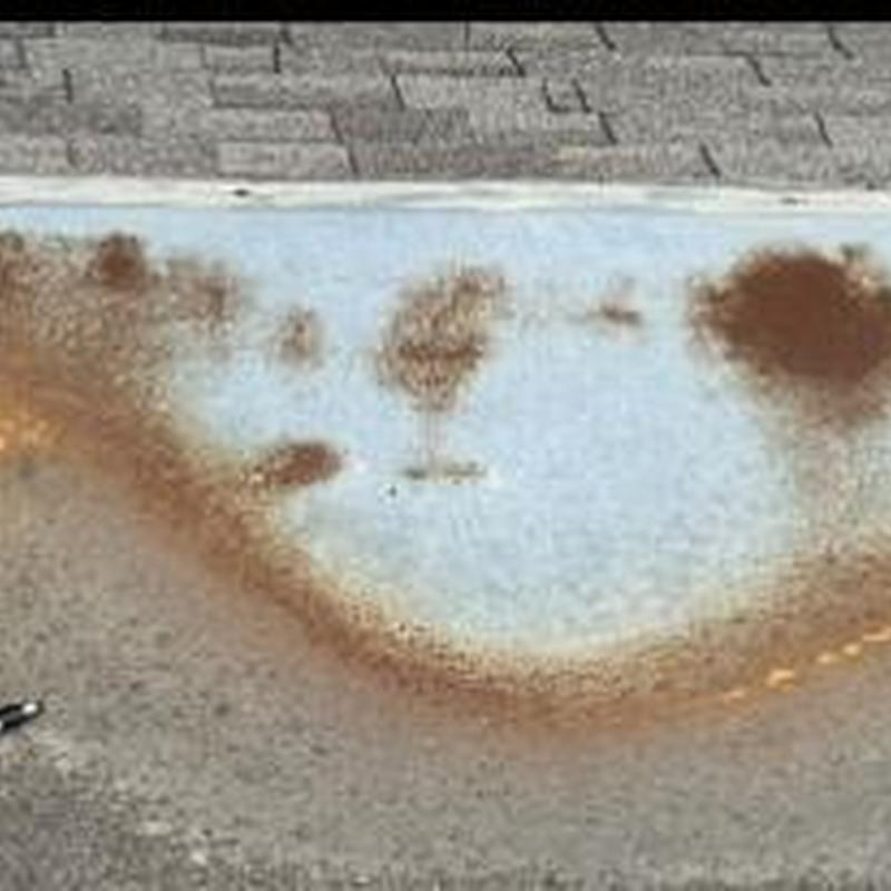 Gutter with rust stains and roof shingle background Gutter with rust stains and roof shingle background