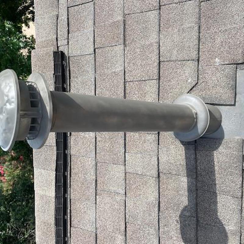 Roof vent pipe on shingle roof with clean gutters Roof vent pipe on shingle roof with clean gutters