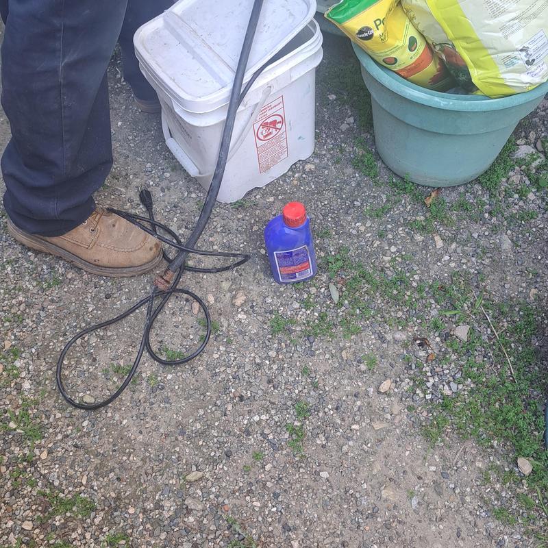 Tankless water heater descaling materials on ground
