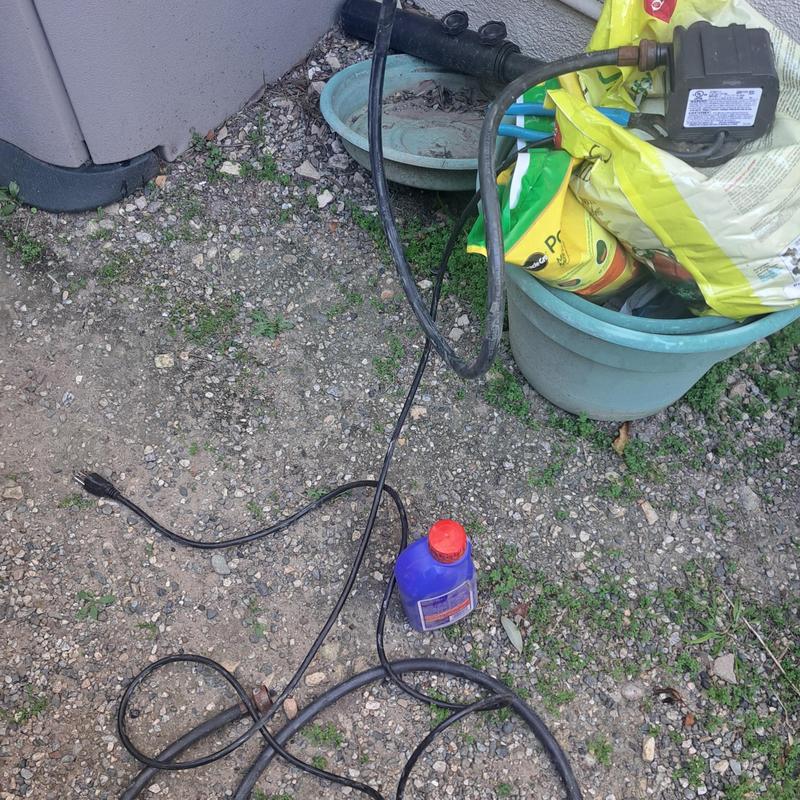 Tankless water heater descaling equipment setup outdoors