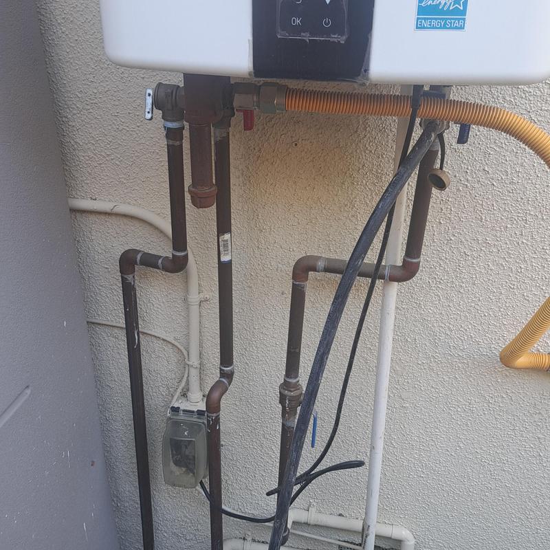 Tankless water heater with connected gas and water pipes