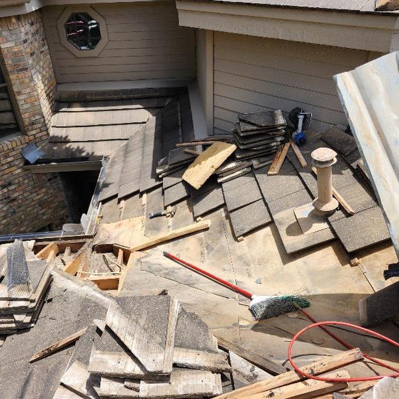 Concrete tile roof with removed tiles and tools