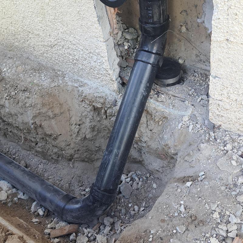 Two way sewer cleanout and drain reroute under walkway