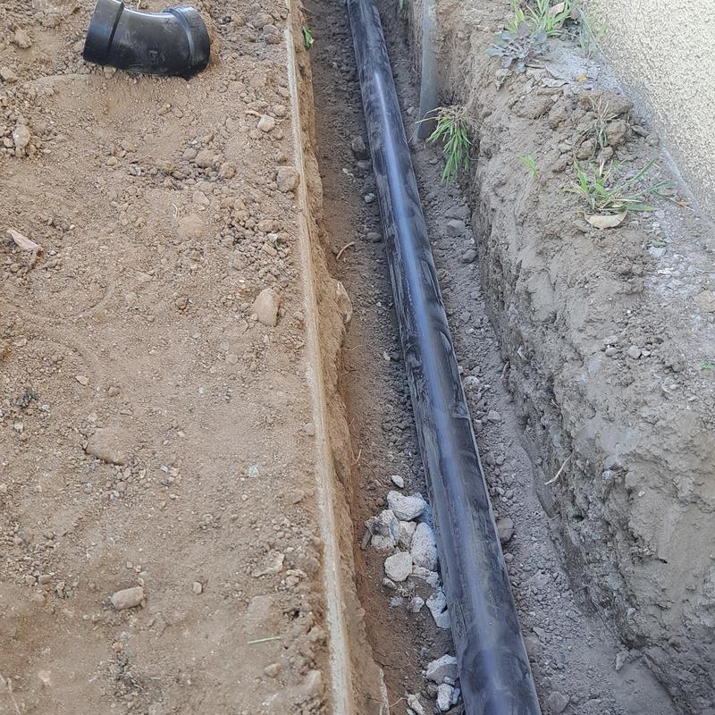 Two-way sewer cleanout pipe installed in trench