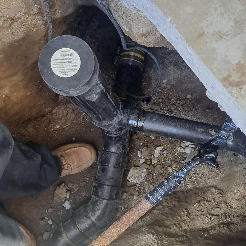 Two-way sewer cleanout pipe installation under walkway