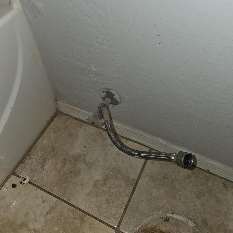 Toilet supply line and angle stop connection near floor