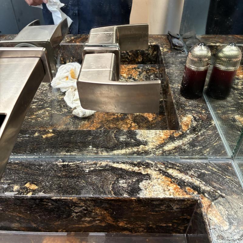 Wall-mounted bathroom faucet handle reattached in sink