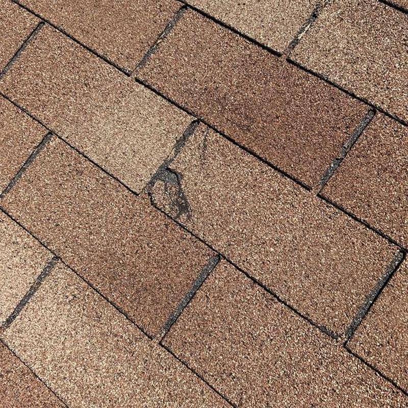 GAF roofing shingles with visible damage close-up