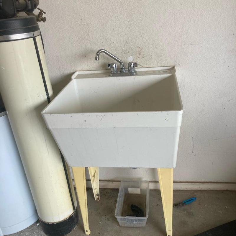 Utility sink with faucet installed in garage area Utility sink with faucet installed in garage area