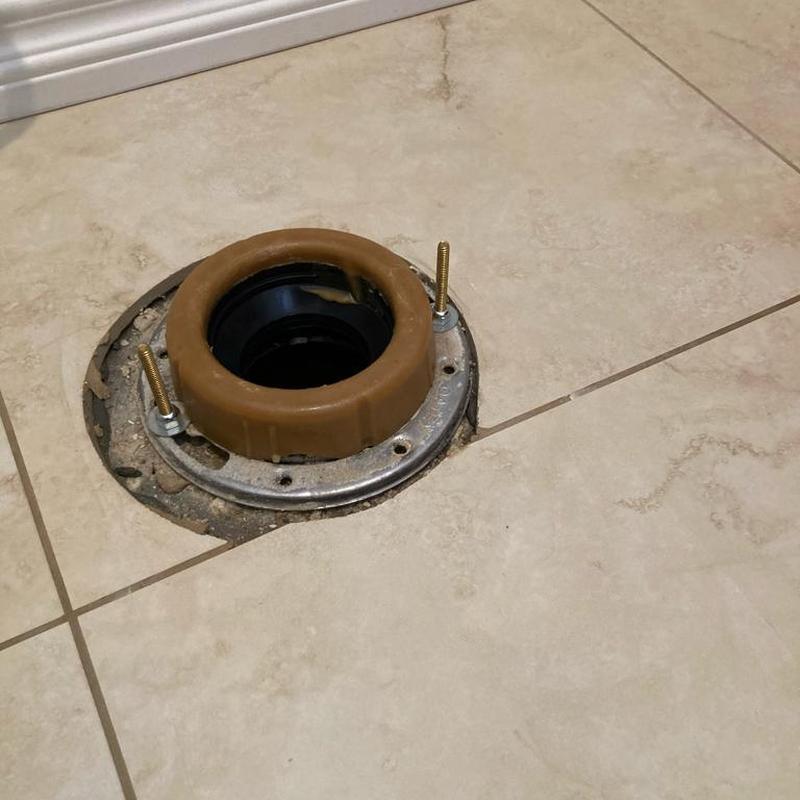 Toilet flange and wax ring installation on tiled floor Toilet flange and wax ring installation on tiled floor