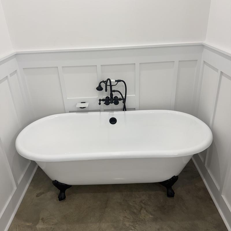 Matte black clawfoot tub with faucet installation
