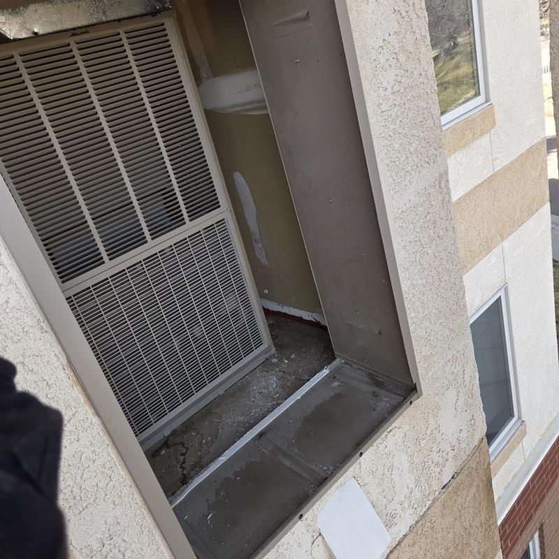 Wall-mounted furnace unit replaced in building exterior slot