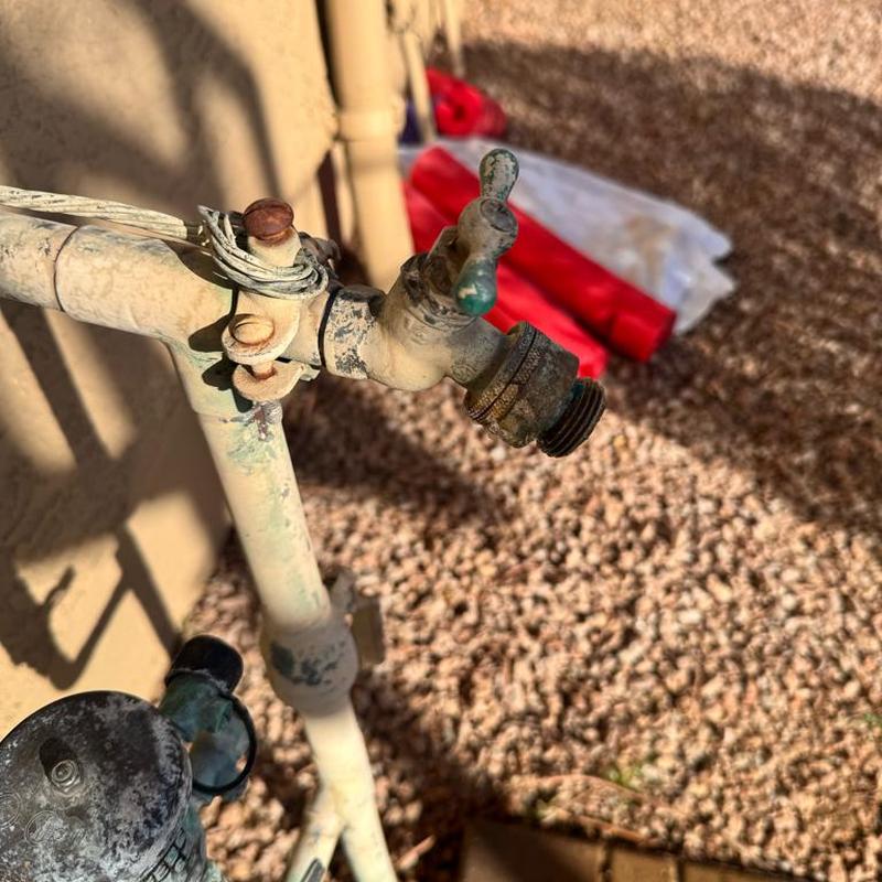 Outdoor hose bib with rusty pipe and fittings