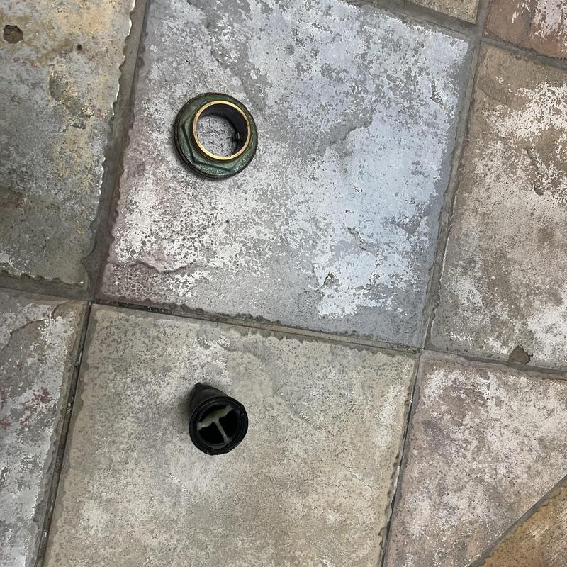 Toilet vacuum breaker parts on tiled floor installation