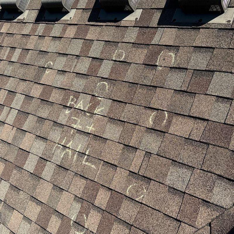 Asphalt shingle roof with hail damage markings
