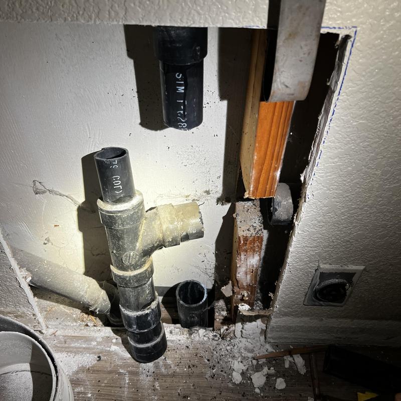 Washer drain plumbing in wall with cutout section Washer drain plumbing in wall with cutout section