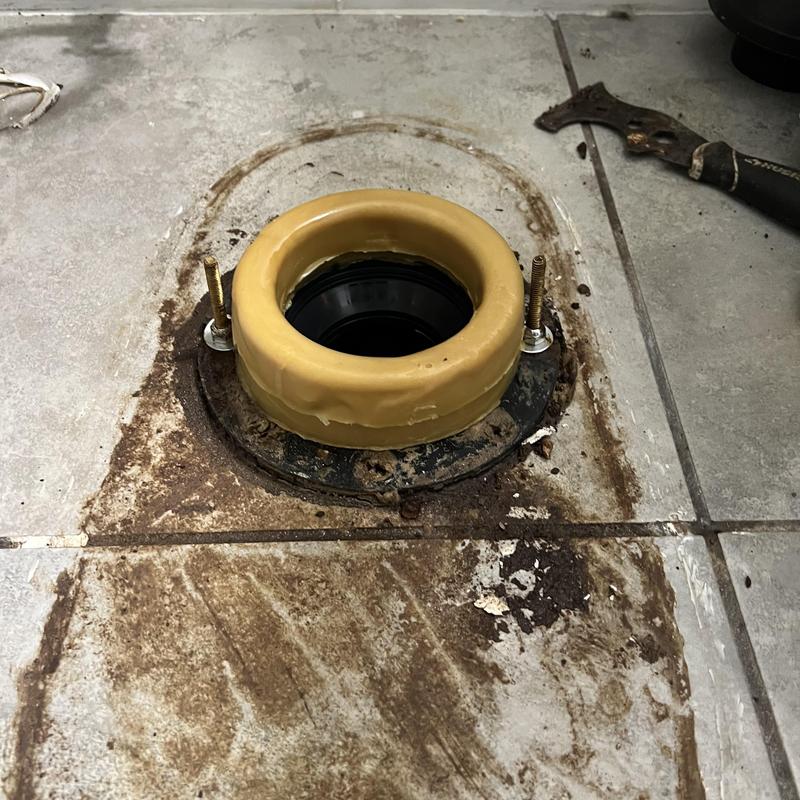 Toilet flange and wax ring installation on tiled floor